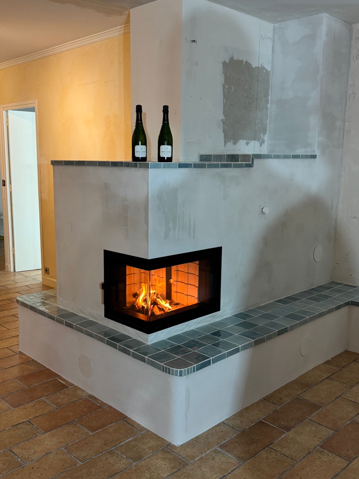 First fire in a glazed corner firebox at handover of the project