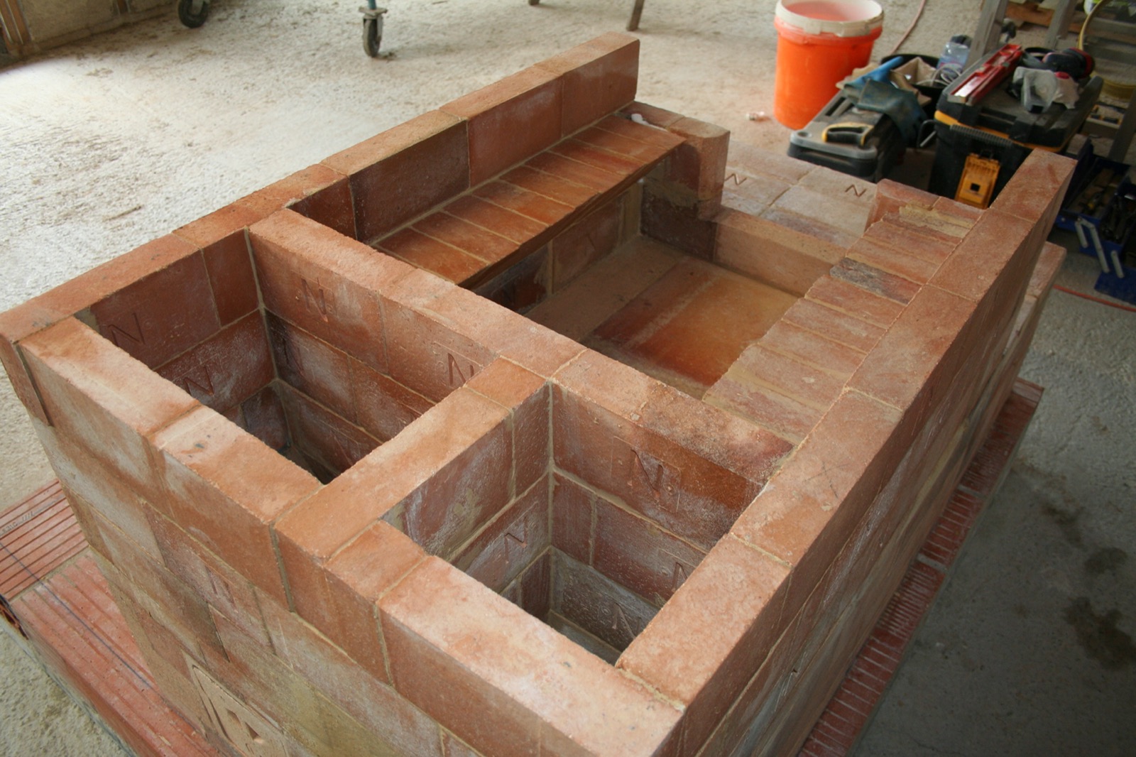 Masonry heater No. 4 built in bricks with an original flue path