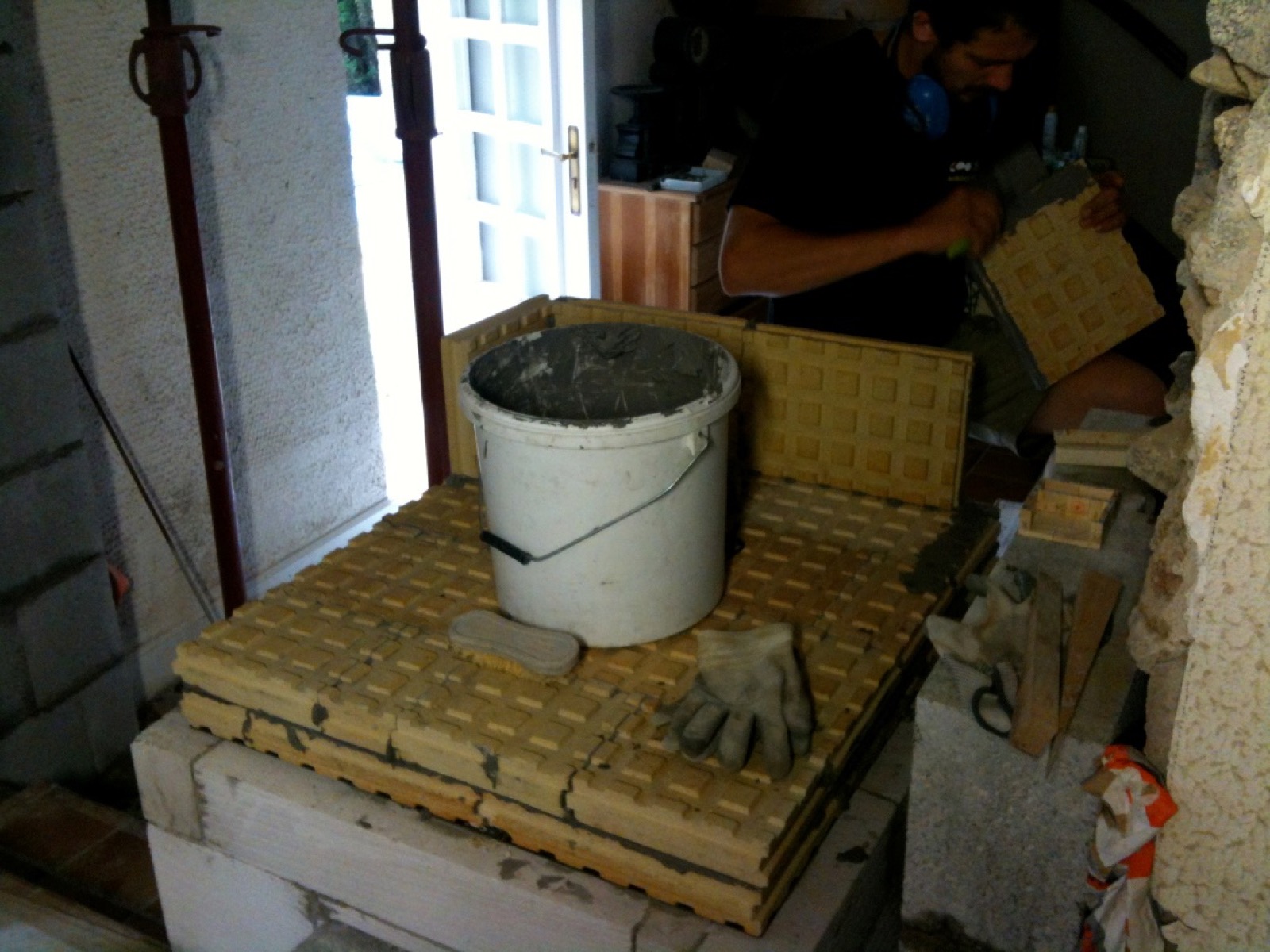 Prefabricated elements and hand-laid stove tiles