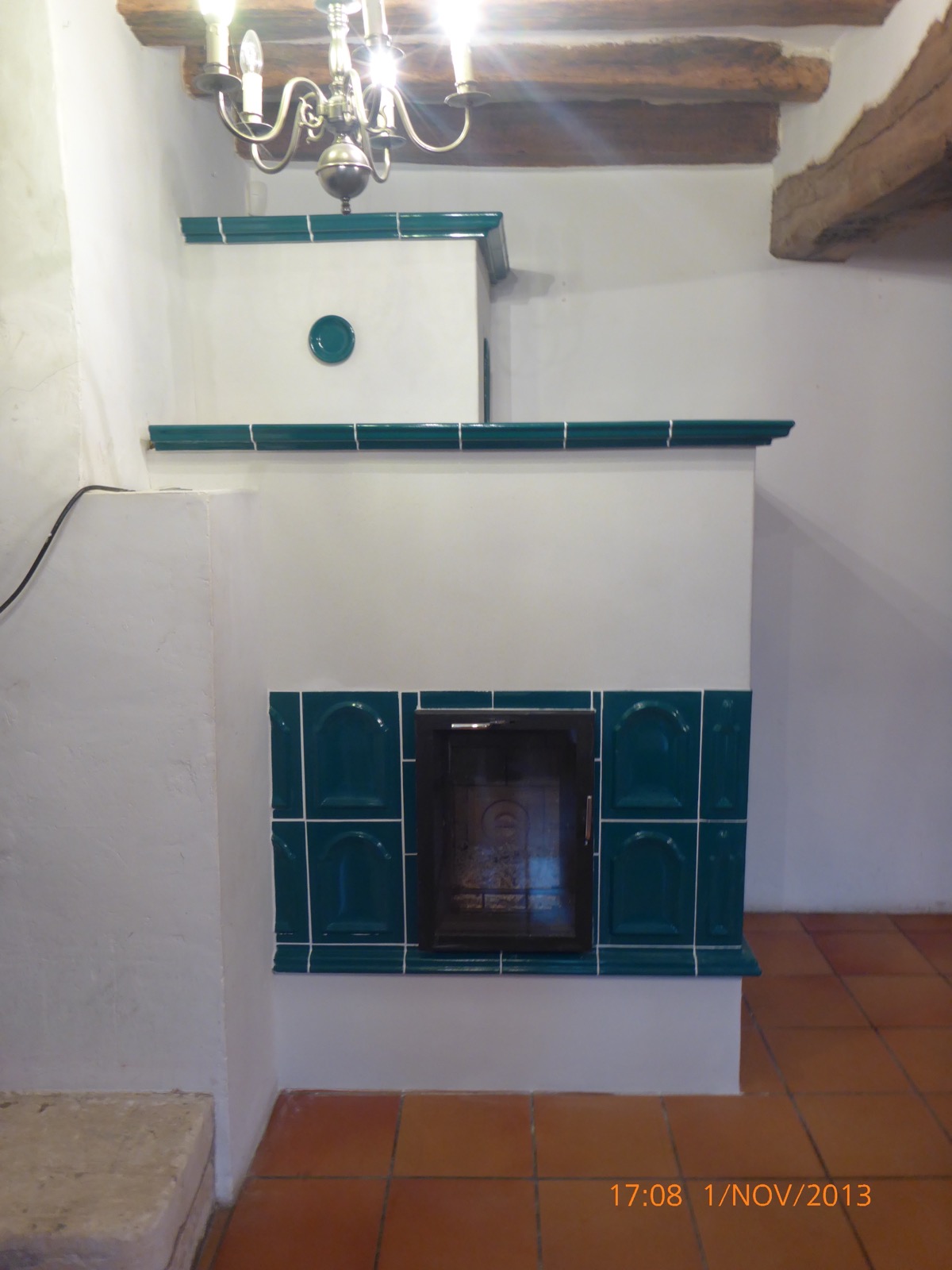 Teal stove tiles in moulded panels