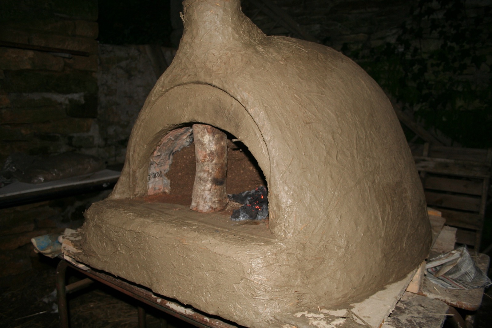 A bread oven in raw earth, shaped by hand