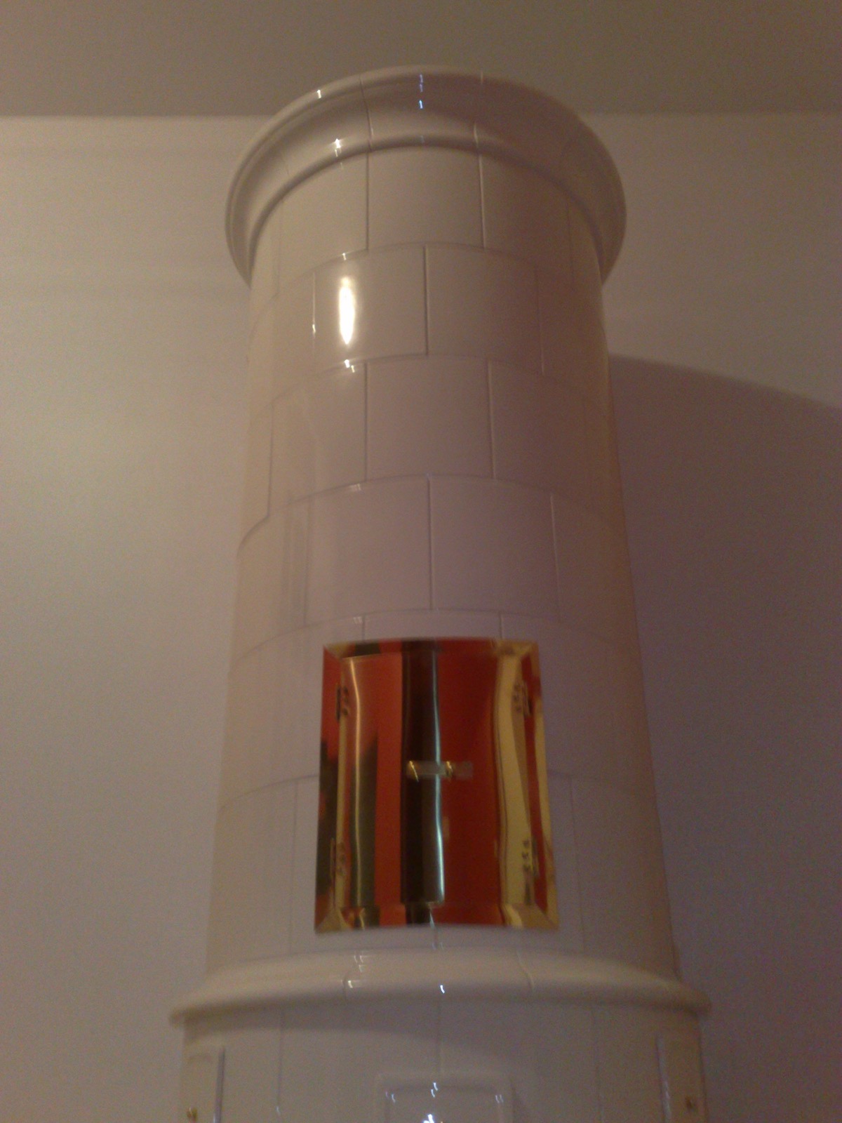Another view of the round Swedish heater in white stove tiles
