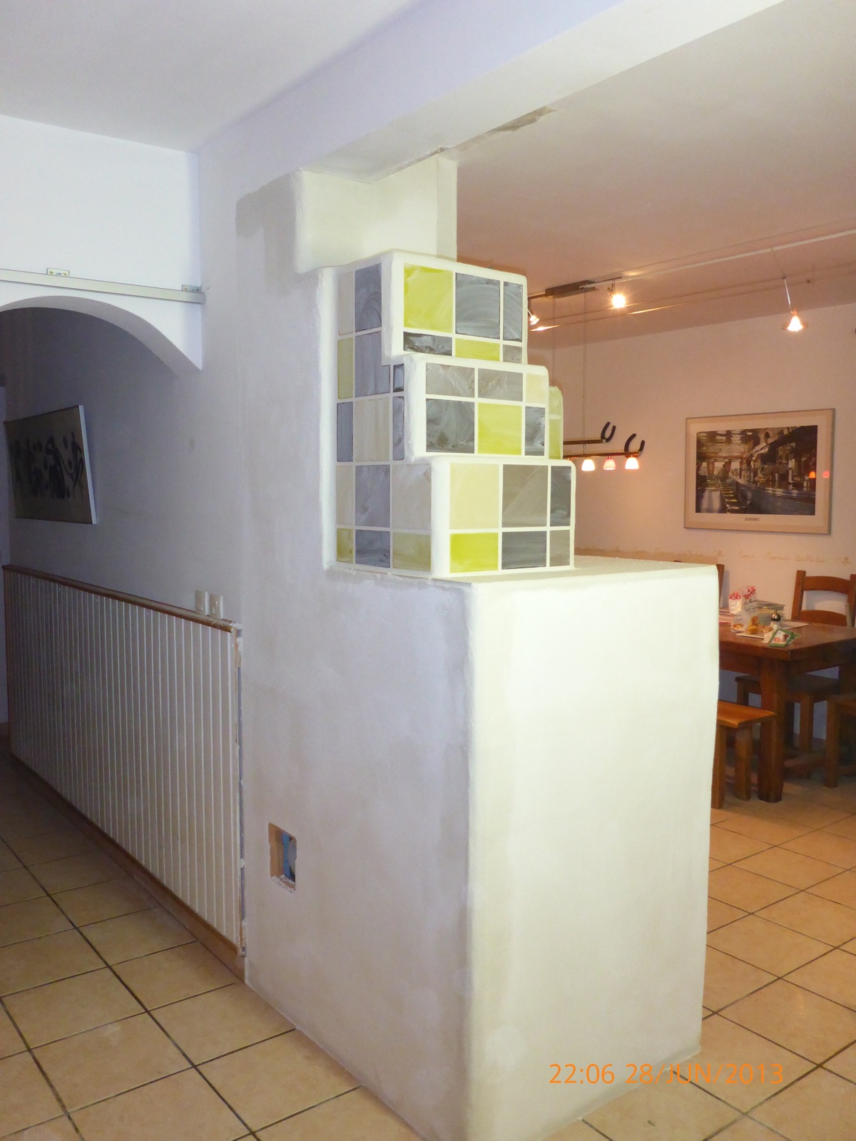 Second view of the green and grey tile crown of the masonry heater