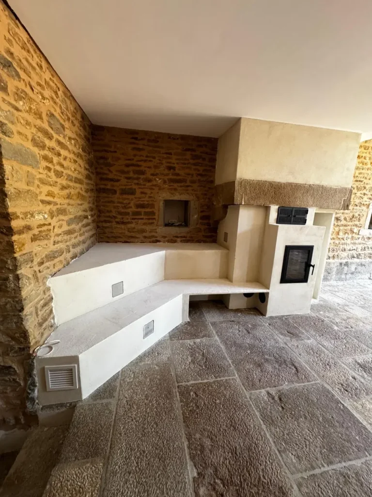 Corner heated bench along the stone walls of the old fireplace