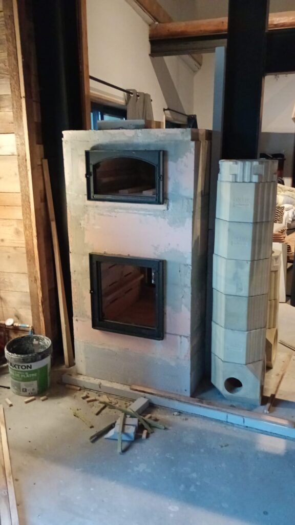 Heater body built, two glazed doors one above the other, insulated flue sections stacked alongside